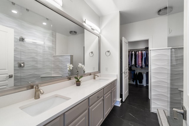 bathroom featuring walk in shower and vanity