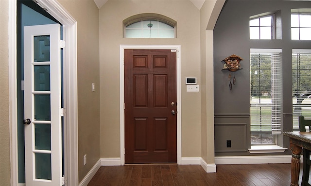 foyer with dark hardwood / wood-style flooring and vaulted ceiling