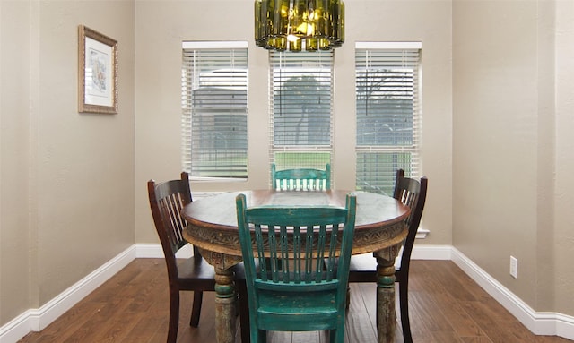 dining space with a notable chandelier and dark wood-type flooring