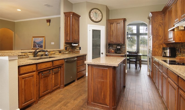 kitchen with backsplash, a center island, sink, and stainless steel appliances