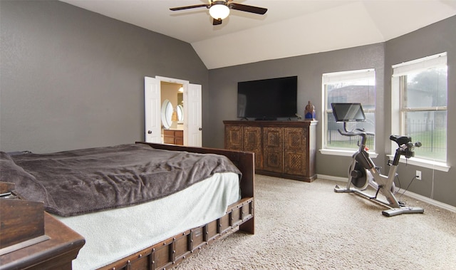 carpeted bedroom with ceiling fan, connected bathroom, and vaulted ceiling