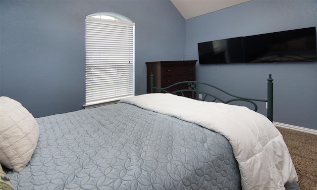 carpeted bedroom featuring lofted ceiling