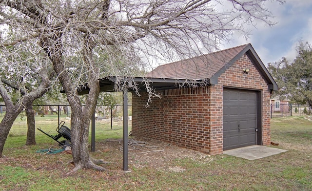 exterior space featuring a yard, an outdoor structure, and a garage