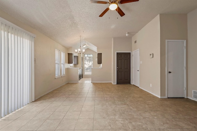 spare room with a textured ceiling, ceiling fan with notable chandelier, vaulted ceiling, and light tile patterned flooring