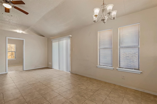 tiled spare room featuring a textured ceiling, ceiling fan with notable chandelier, and lofted ceiling