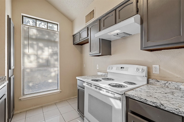 kitchen featuring dark brown cabinetry, white electric range oven, a textured ceiling, lofted ceiling, and light tile patterned floors