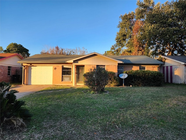 ranch-style house featuring a garage and a front yard