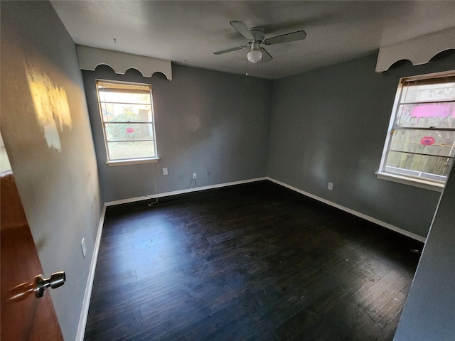 empty room featuring ceiling fan and dark hardwood / wood-style flooring