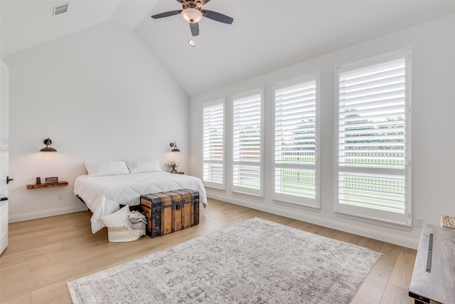 bedroom with ceiling fan, vaulted ceiling, and light hardwood / wood-style flooring