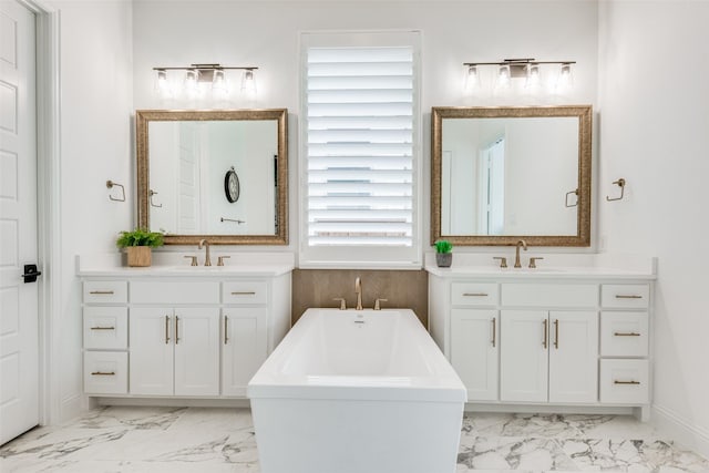 bathroom featuring vanity, plenty of natural light, and a tub