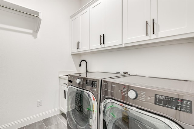 laundry room with washer and clothes dryer, cabinets, light tile patterned floors, and sink