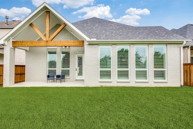 back of house featuring a yard and a patio