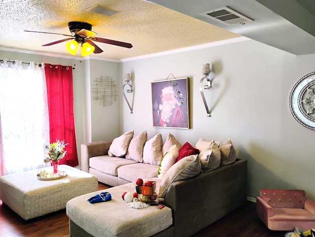 living room with ceiling fan, dark hardwood / wood-style flooring, a textured ceiling, and ornamental molding