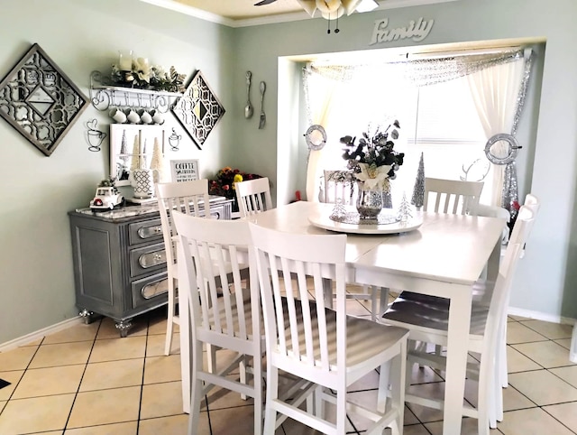 tiled dining area with a wealth of natural light and crown molding