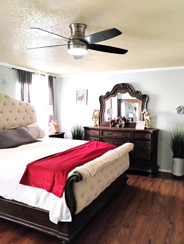 bedroom with a textured ceiling, dark hardwood / wood-style floors, and ceiling fan