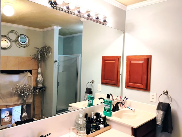 bathroom with vanity, an enclosed shower, and crown molding