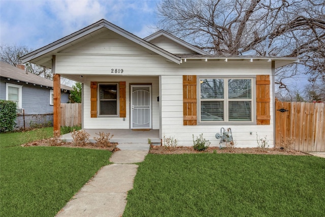 bungalow-style house with covered porch and a front yard