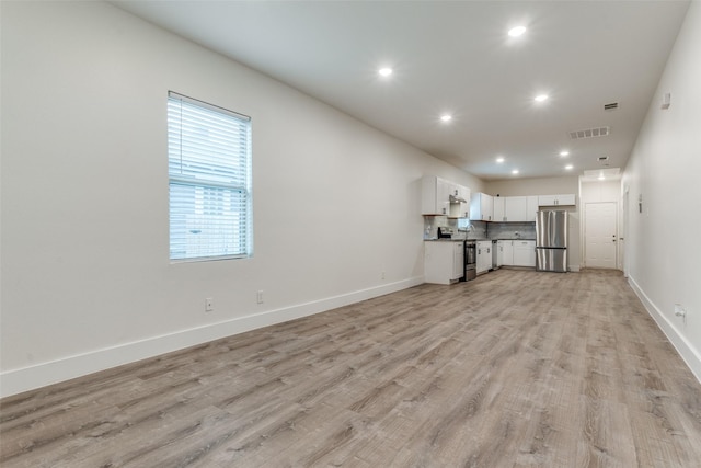 unfurnished living room featuring light hardwood / wood-style floors