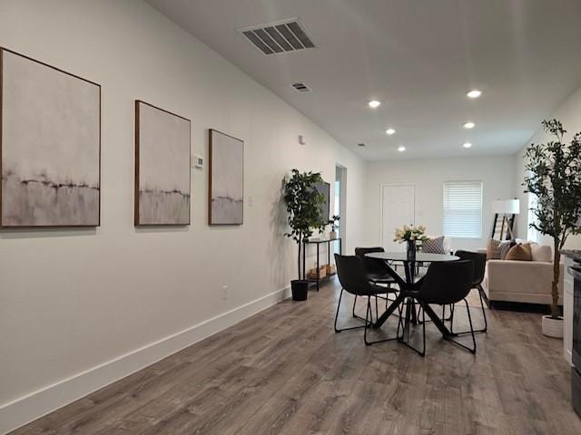 dining space featuring wood-type flooring