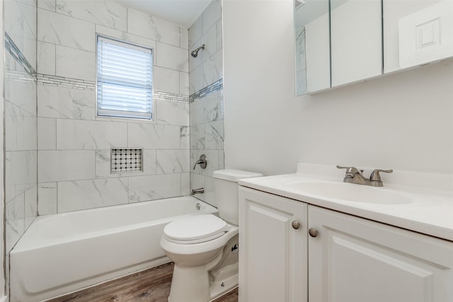 full bathroom featuring wood-type flooring, vanity, toilet, and tiled shower / bath