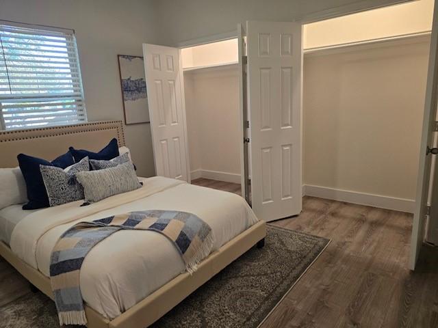 bedroom featuring a closet and dark hardwood / wood-style flooring