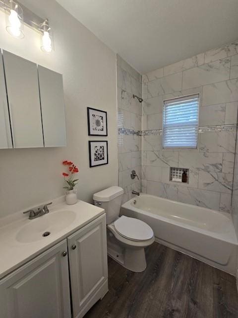 full bathroom with toilet, vanity, tiled shower / bath combo, and hardwood / wood-style flooring