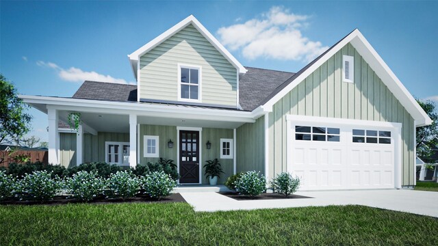 view of front of property with a garage, a front yard, and covered porch