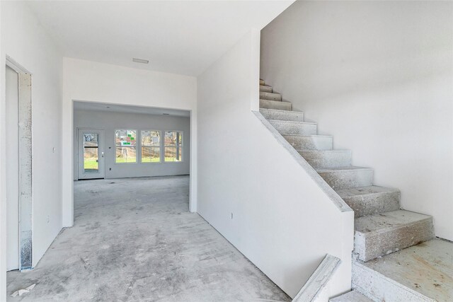 stairway with concrete floors