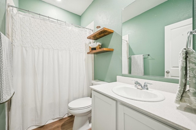 bathroom with vanity, hardwood / wood-style flooring, and toilet