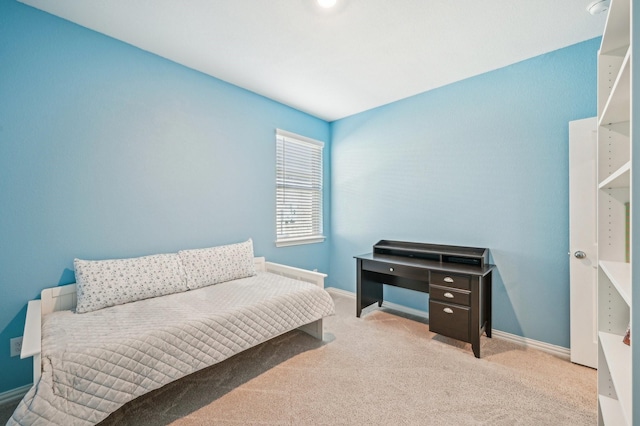 carpeted bedroom featuring baseboards