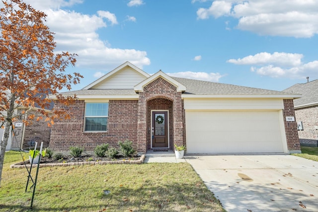 ranch-style house featuring brick siding, a front lawn, concrete driveway, roof with shingles, and an attached garage