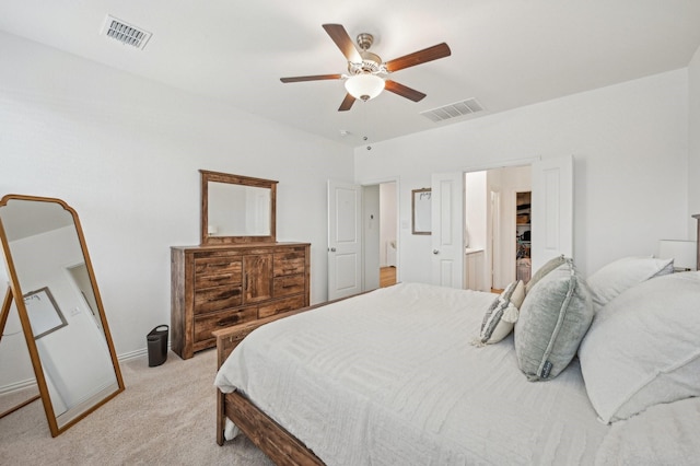 bedroom with visible vents, light colored carpet, baseboards, and a ceiling fan