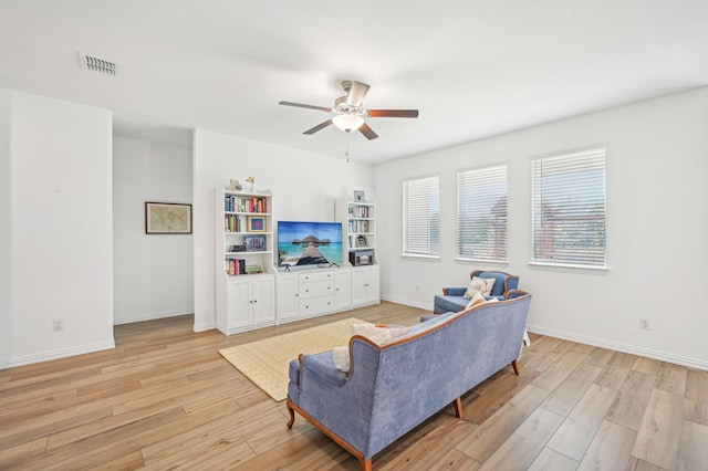 living room with ceiling fan and light wood-type flooring