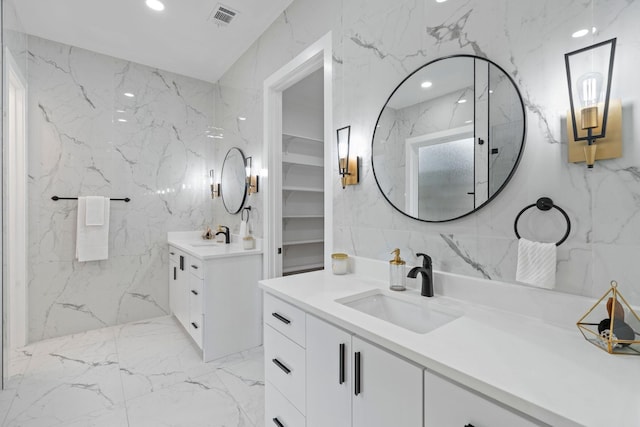 bathroom with vanity and tile walls