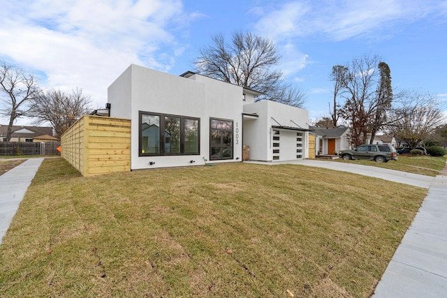 view of front of house with a garage and a front lawn