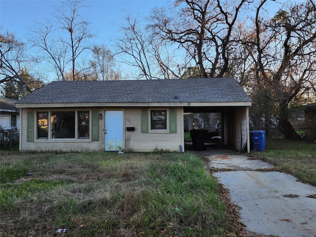 ranch-style home featuring a carport