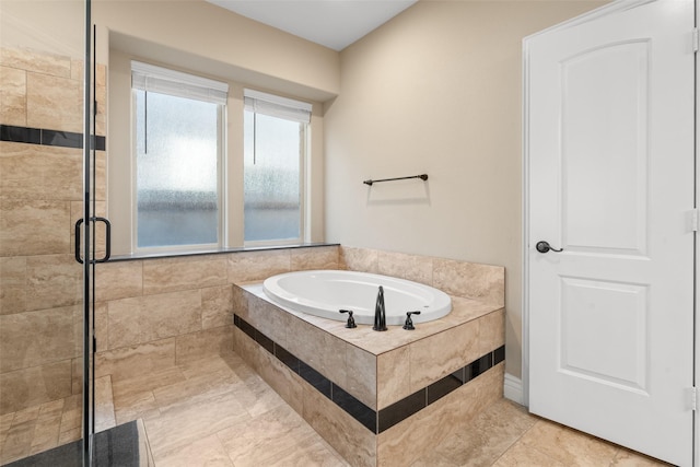 bathroom with tile patterned flooring and separate shower and tub