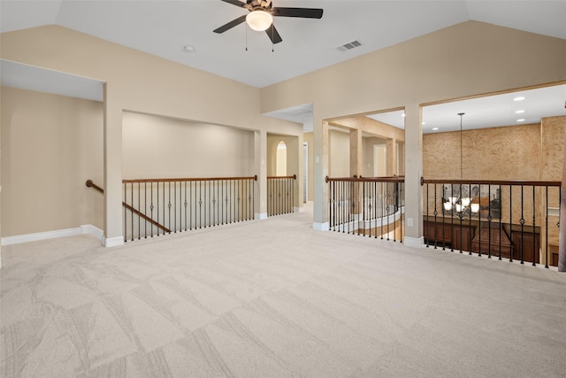 carpeted empty room featuring ceiling fan and vaulted ceiling