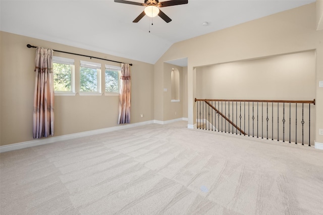 carpeted spare room with ceiling fan and lofted ceiling