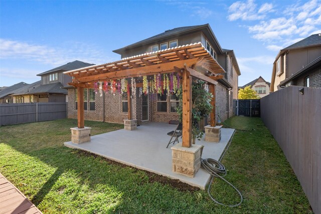 rear view of house featuring a yard, a pergola, and a patio area