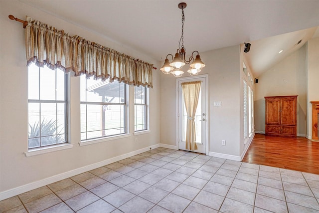 unfurnished dining area with lofted ceiling, a chandelier, and light tile patterned floors