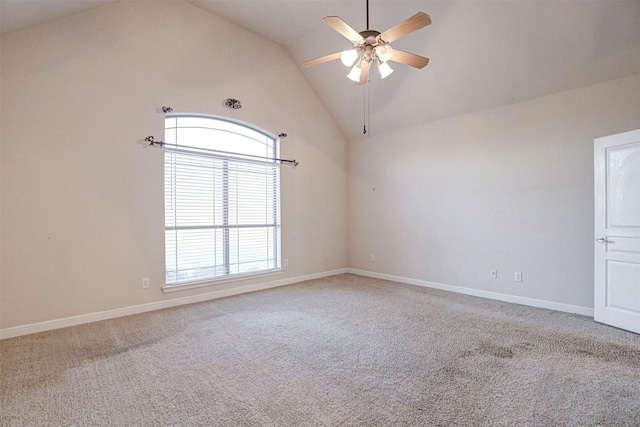 carpeted empty room featuring ceiling fan and high vaulted ceiling