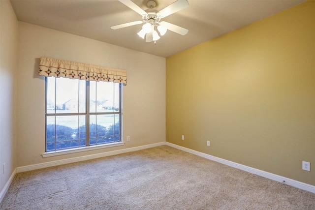 unfurnished room featuring light colored carpet and ceiling fan