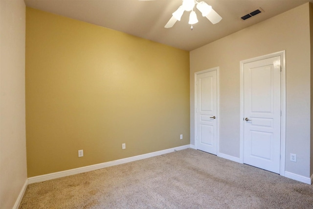 unfurnished bedroom with ceiling fan and light carpet