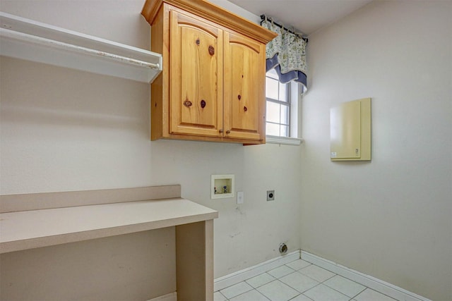 washroom featuring cabinets, hookup for a washing machine, light tile patterned floors, and electric dryer hookup