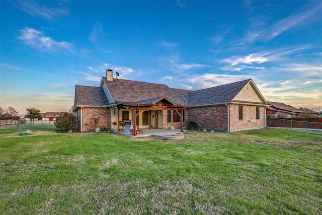 view of front of property with a yard and a patio area