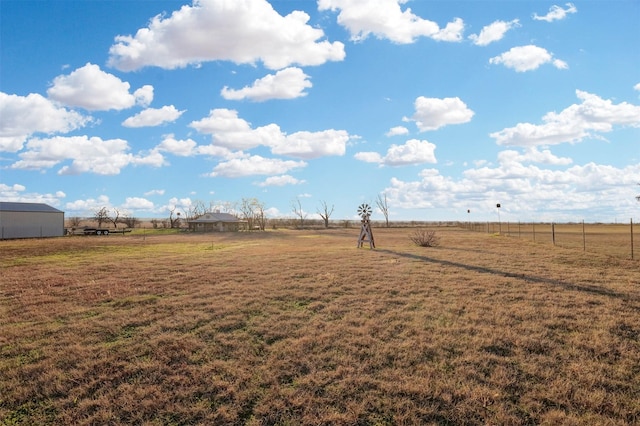 view of yard with a rural view