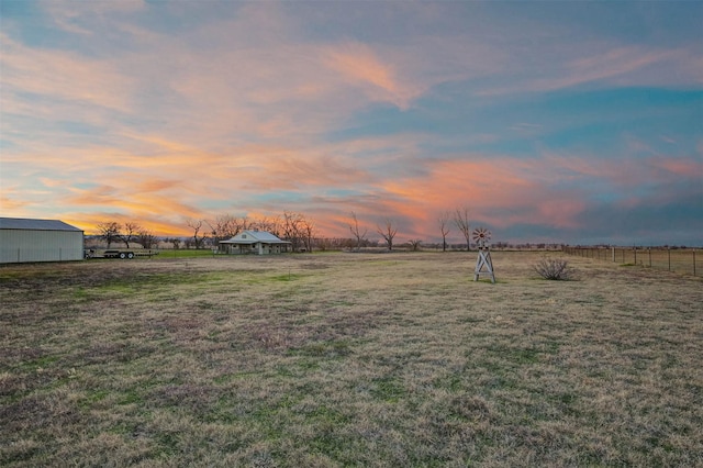 yard at dusk with a rural view