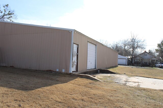 view of outbuilding featuring a yard and a garage