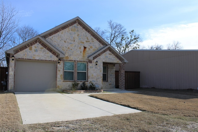 view of front of property with a garage and a front yard